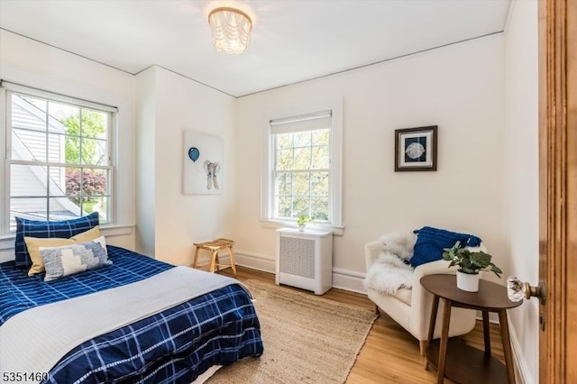 bedroom featuring baseboards and light wood-style flooring