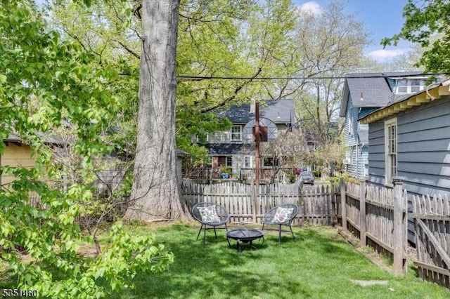 view of yard featuring fence and an outdoor fire pit