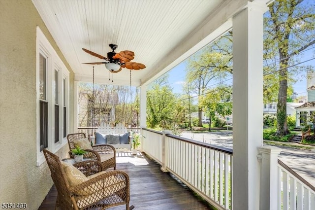balcony featuring a porch and a ceiling fan