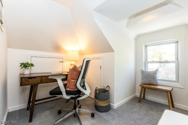 carpeted office featuring baseboards and vaulted ceiling