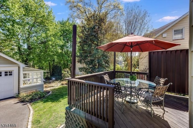 wooden terrace featuring a yard and outdoor dining space