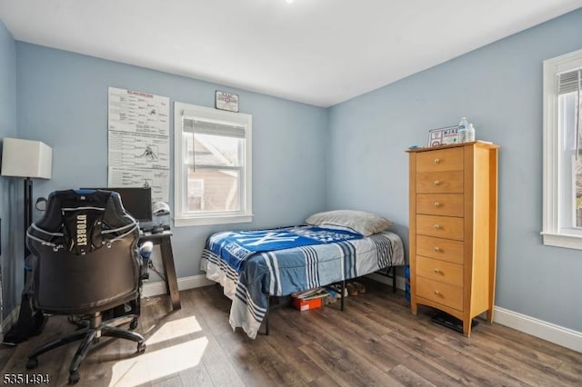 bedroom featuring baseboards and wood finished floors