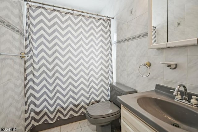 bathroom with curtained shower, tile walls, toilet, and vanity