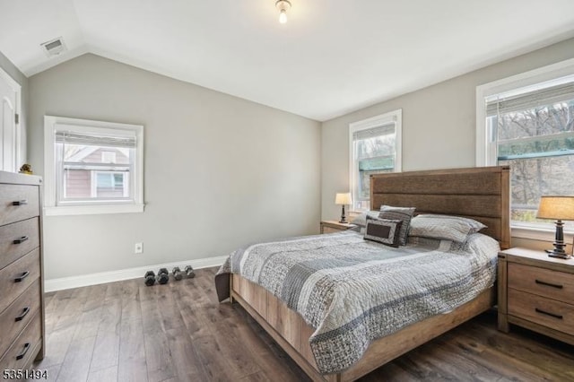 bedroom featuring baseboards, vaulted ceiling, visible vents, and dark wood-style floors