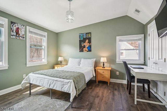 bedroom with visible vents, baseboards, lofted ceiling, and dark wood-style flooring