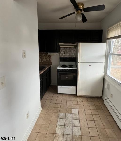 244 Dupont Ave, Hopatcong Boro, NJ 07843 - kitchen with freestanding refrigerator, decorative backsplash, range with electric stovetop, under cabinet range hood, and a baseboard radiator