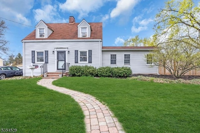 cape cod home with a chimney and a front lawn