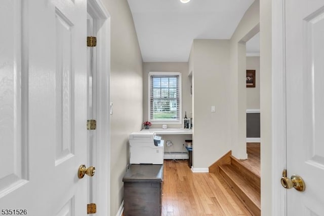 bathroom with baseboards, wood finished floors, and baseboard heating