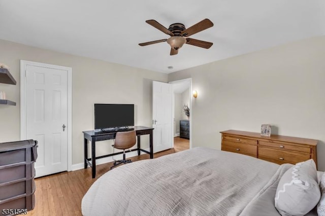 bedroom featuring baseboards, a ceiling fan, and wood finished floors