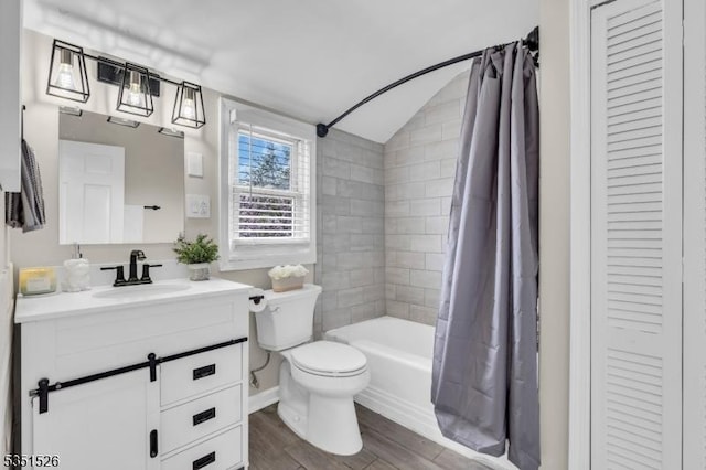 full bath featuring lofted ceiling, wood finished floors, toilet, vanity, and shower / bath combo