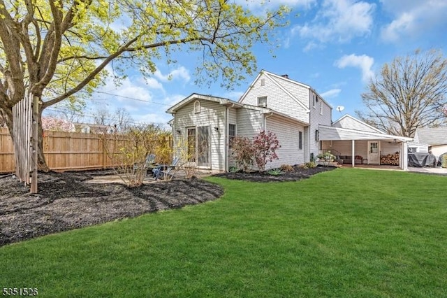 exterior space featuring a lawn and fence