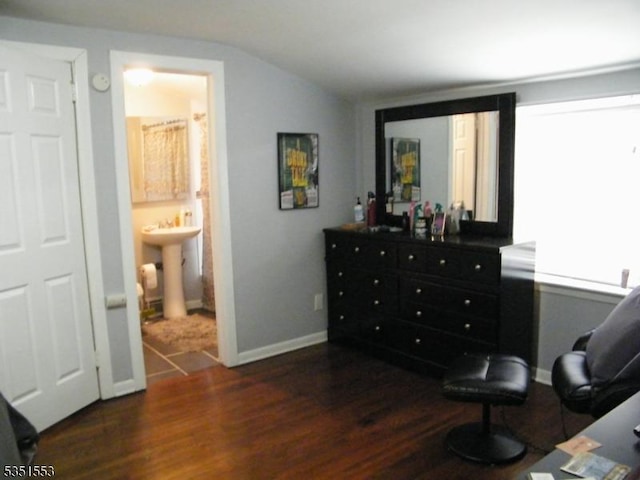 living area with baseboards, wood finished floors, and lofted ceiling