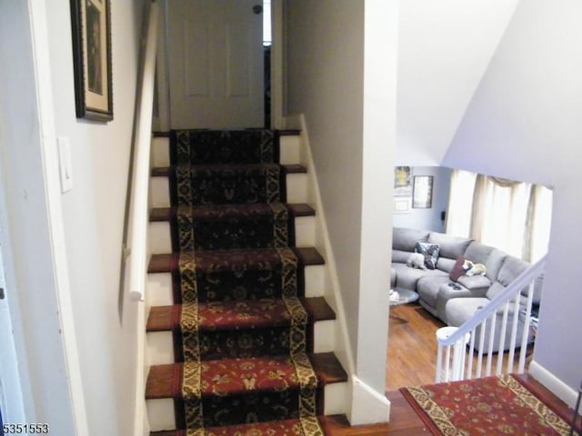 stairs featuring baseboards and wood finished floors