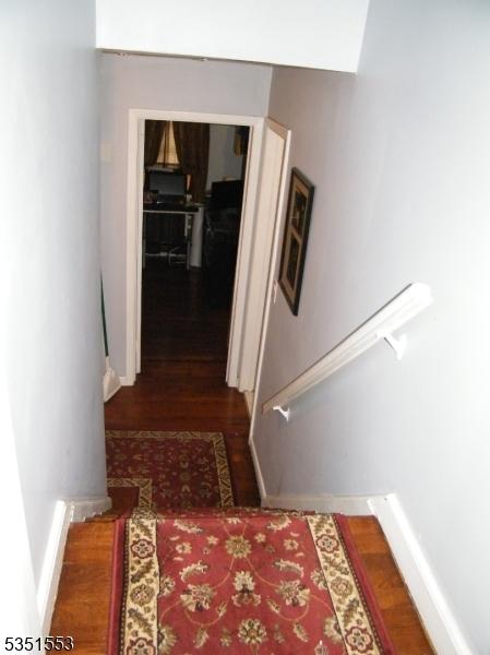 1408 Orchard Ter, Hillside Twp, NJ 07205 - corridor with baseboards, stairs, and wood finished floors