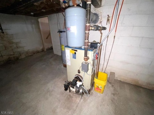 utility room with heating unit and water heater