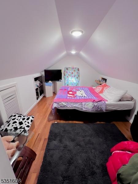 79 Shaler Ave, Fairview Boro, NJ 07022 - bedroom with lofted ceiling and wood finished floors