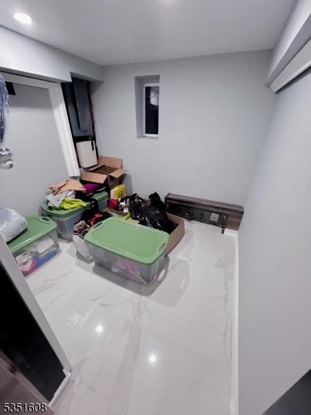79 Shaler Ave, Fairview Boro, NJ 07022 - finished below grade area featuring marble look tiles