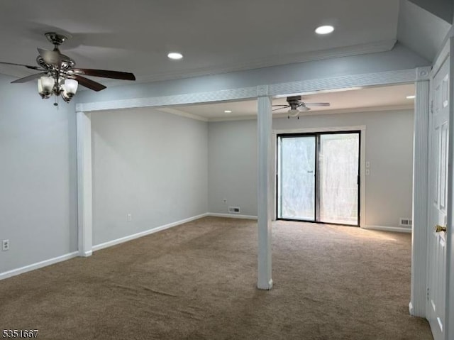 interior space with carpet floors, a ceiling fan, baseboards, and ornamental molding