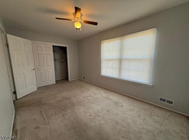 unfurnished bedroom with carpet floors, baseboards, a closet, and visible vents