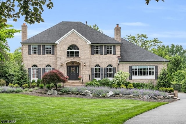 146 Linden Dr, Bernards Twp, NJ 07920 - georgian-style home featuring a chimney, brick siding, a front lawn, and a shingled roof