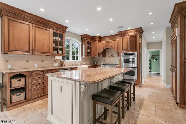 146 Linden Dr, Bernards Twp, NJ 07920 - kitchen with appliances with stainless steel finishes, a kitchen island, decorative backsplash, recessed lighting, and brown cabinets