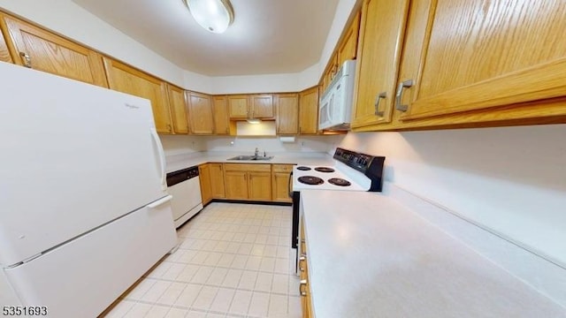 kitchen with a sink, light countertops, and white appliances