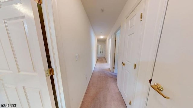 hallway with light colored carpet