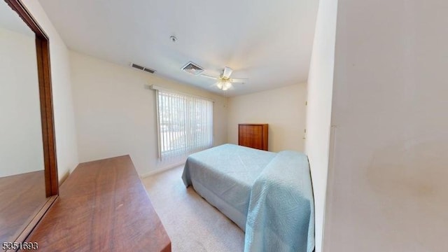 carpeted bedroom featuring visible vents and ceiling fan