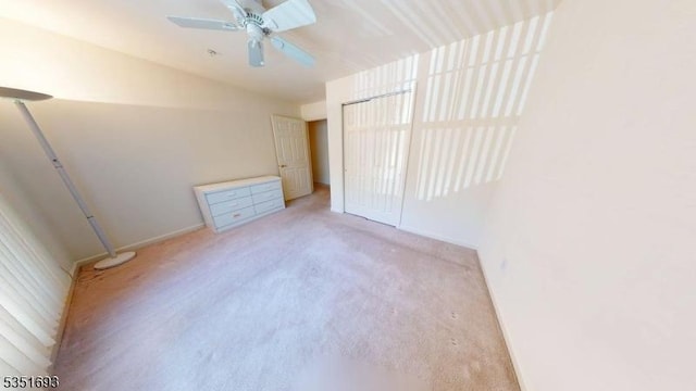 unfurnished bedroom with carpet floors, baseboards, ceiling fan, and a closet
