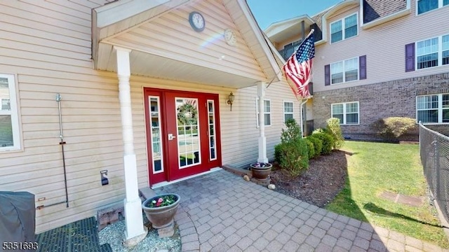 doorway to property with a lawn