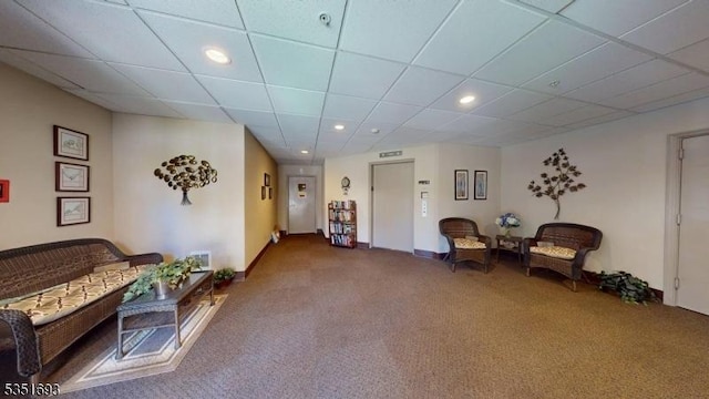 living area with visible vents, carpet, recessed lighting, and a paneled ceiling
