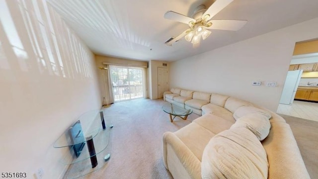living room with ceiling fan and light colored carpet