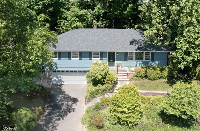 27 Belgrade Ter, West Orange Twp, NJ 07052 - view of front of home with asphalt driveway, a garage, and roof with shingles
