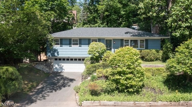 27 Belgrade Ter, West Orange Twp, NJ 07052 - view of front facade featuring driveway, a garage, and a chimney