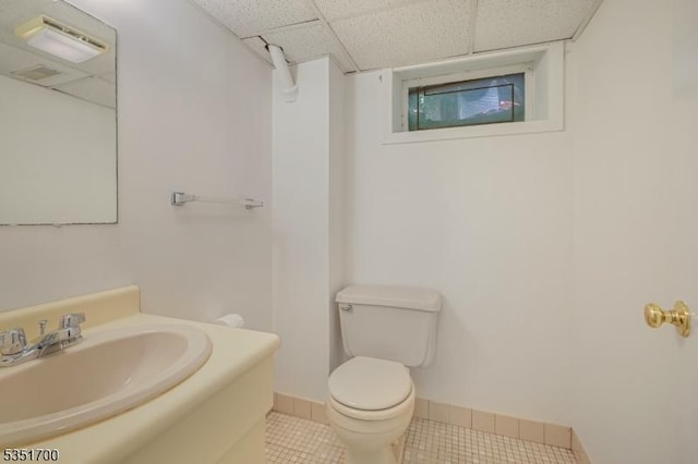 27 Belgrade Ter, West Orange Twp, NJ 07052 - bathroom featuring a paneled ceiling, toilet, tile patterned flooring, vanity, and baseboards