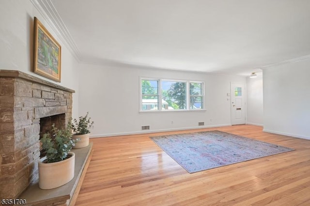 27 Belgrade Ter, West Orange Twp, NJ 07052 - unfurnished living room featuring light wood finished floors, crown molding, a stone fireplace, and baseboards