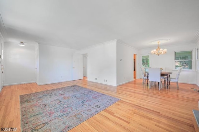 27 Belgrade Ter, West Orange Twp, NJ 07052 - unfurnished living room with a chandelier, ornamental molding, light wood finished floors, and baseboards