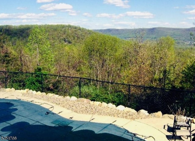 property view of mountains featuring a view of trees