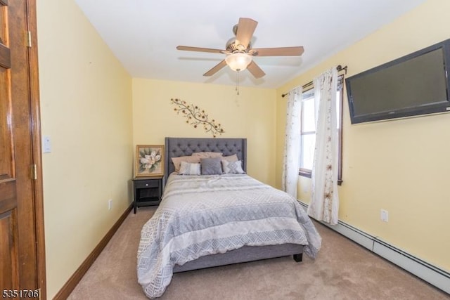 bedroom with baseboard heating, baseboards, ceiling fan, and carpet flooring