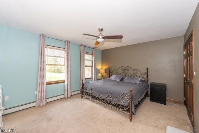bedroom with a baseboard heating unit, a ceiling fan, and carpet flooring
