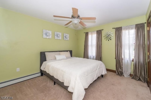 bedroom featuring light carpet, a baseboard heating unit, and ceiling fan
