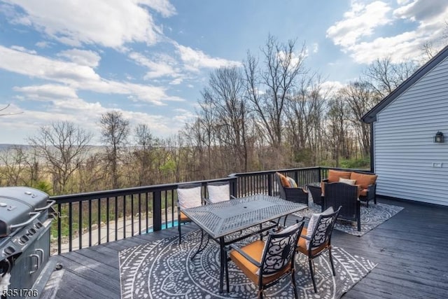 wooden deck with an outdoor hangout area, area for grilling, and outdoor dining space