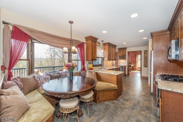 dining area with recessed lighting, a notable chandelier, and baseboards