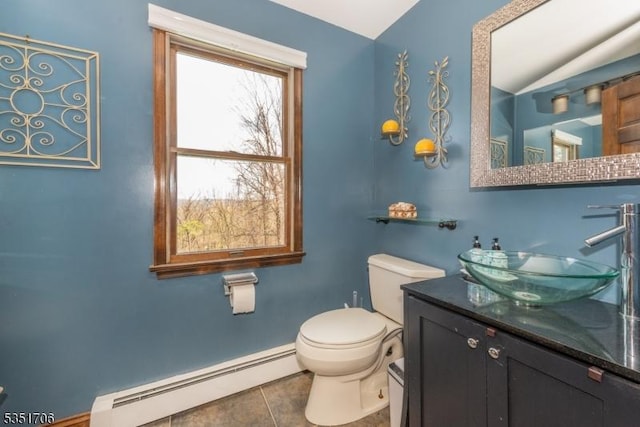 bathroom featuring baseboard heating, toilet, vaulted ceiling, vanity, and tile patterned flooring