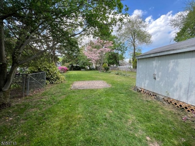 view of yard featuring fence and a patio