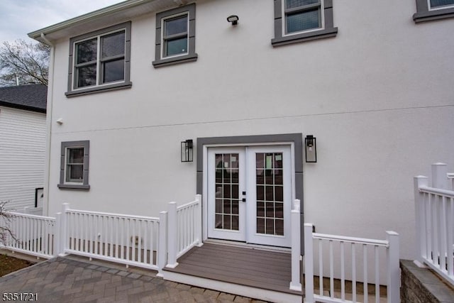 doorway to property featuring stucco siding and french doors