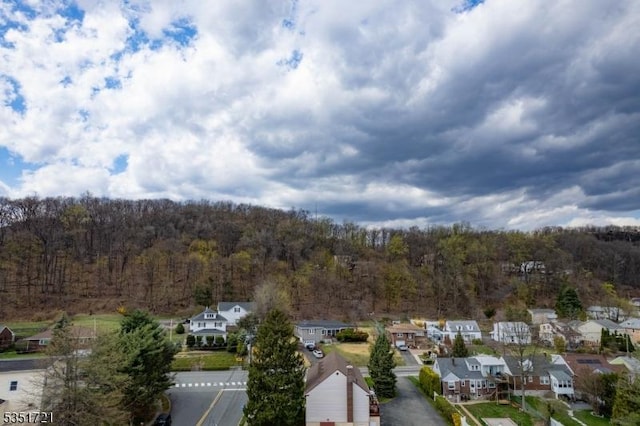 birds eye view of property with a forest view and a residential view