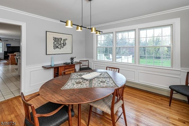 161 Orchard Rd, Montgomery Twp, NJ 08558 - dining area with a decorative wall, crown molding, light wood-style flooring, and wainscoting