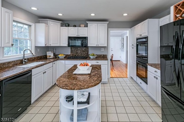 161 Orchard Rd, Montgomery Twp, NJ 08558 - kitchen with black appliances, open shelves, dark stone countertops, and a sink