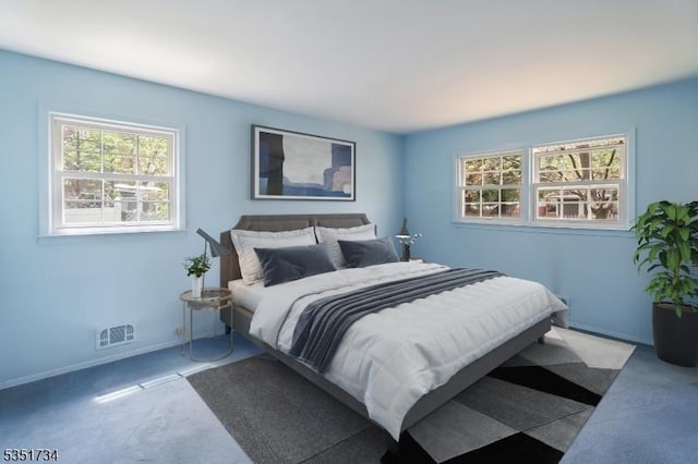 carpeted bedroom with visible vents, baseboards, and multiple windows